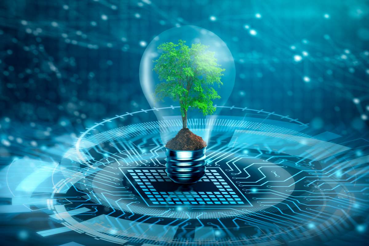Green tree inside a lightbulb on tech background